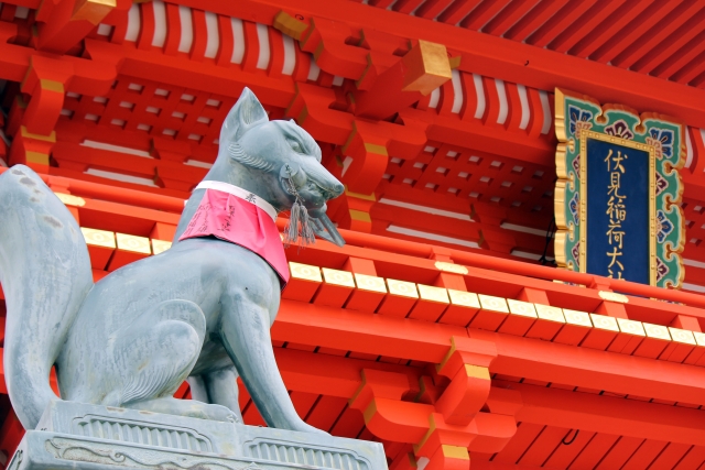 Statue of a sacred fox holding a key and a scroll